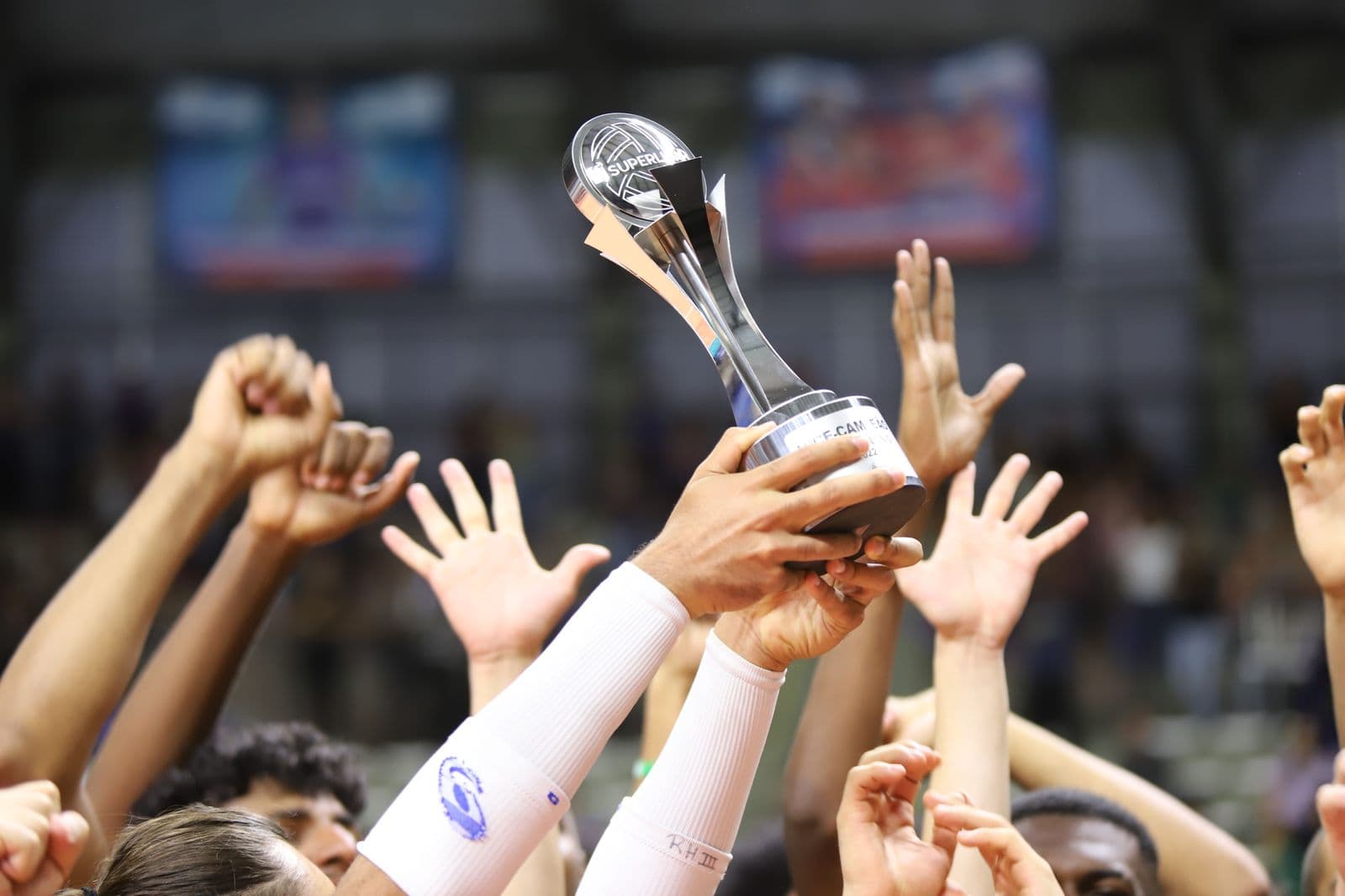 Trophy lift, hands raised in celebration
