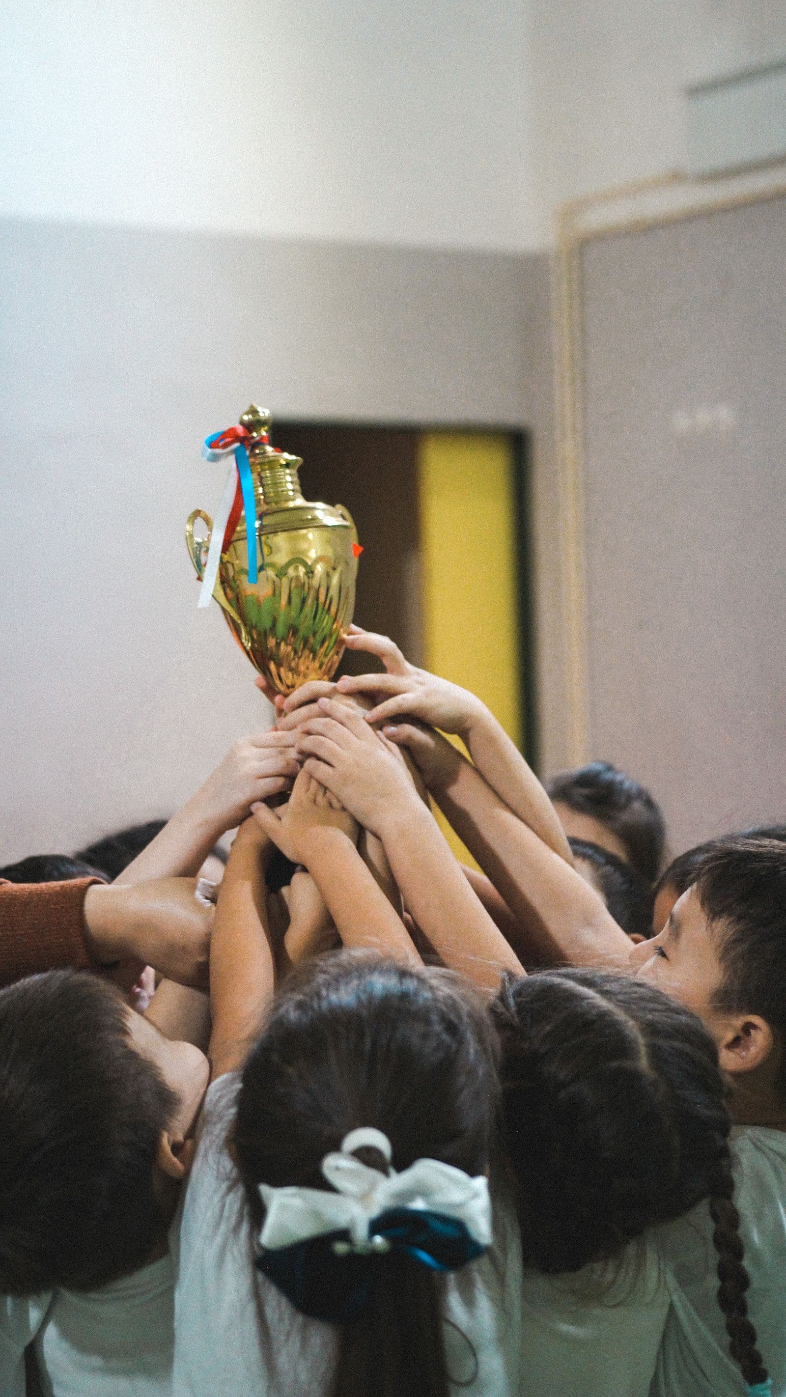 Young players lifting a trophy together